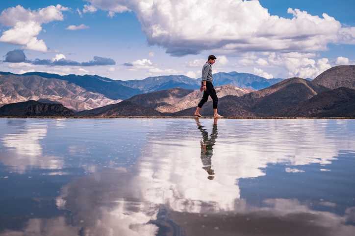 A man walking through Hierve el Agua travertine.