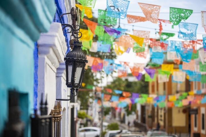 Colorful mexican flags and colonial architecture in Los Cabos Downtown.