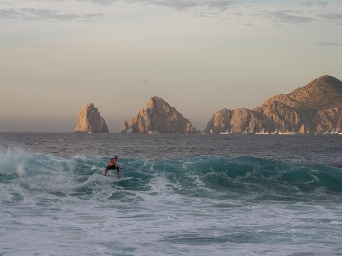 A surfer through the sea waves near Cabo San Lucas.