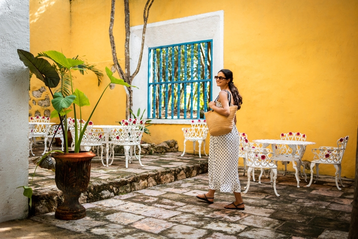 A woman strolling through coffee tables in the La Roma neighborhood.